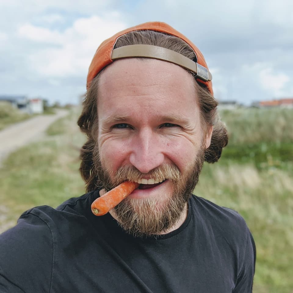 Christian eating a carrot at Lild Strand